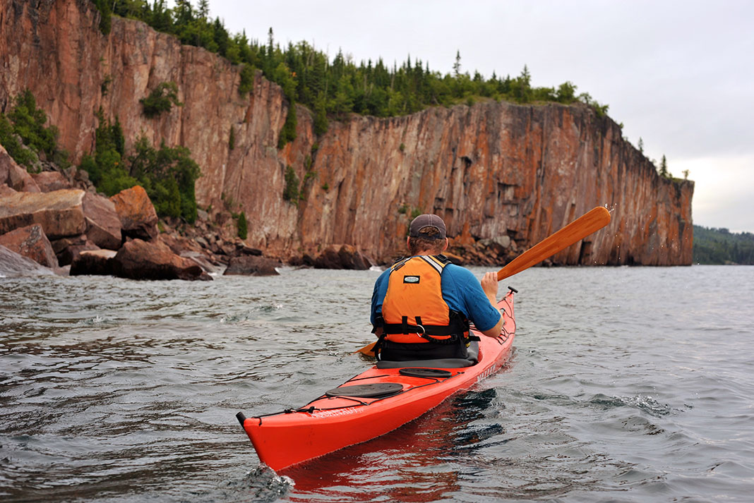 a man paddles along the Lake Superior Trail