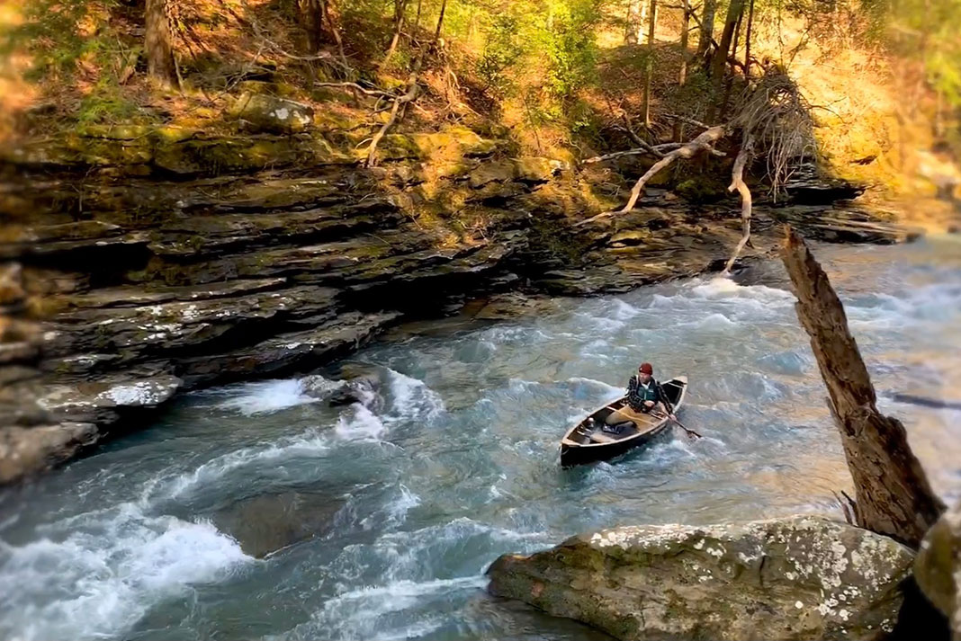 man canoes through rapids in Alabama