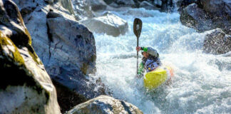 person racing through rapids in a Pyranha whitewater kayak