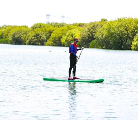 a man paddles a cheap standup paddleboard