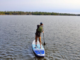 man stands and paddles the ISLE Pioneer 2.0 standup paddleboard
