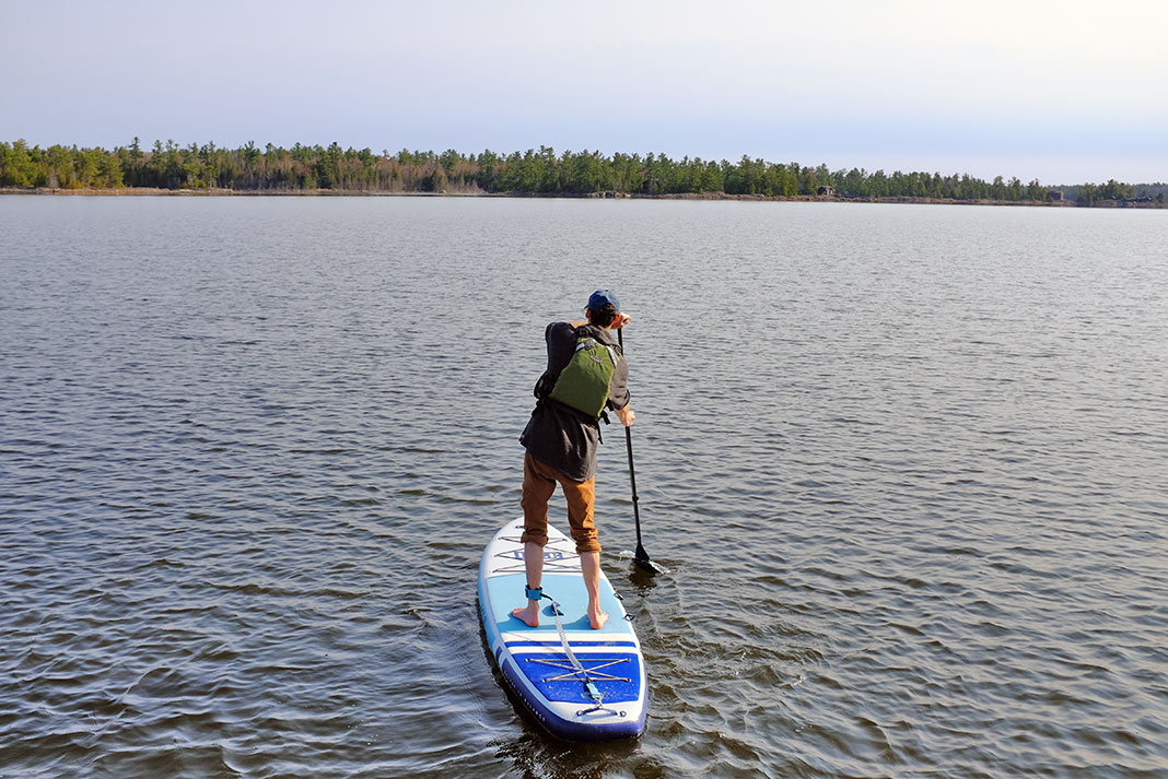 man stands and paddles the ISLE Pioneer 2.0 standup paddleboard