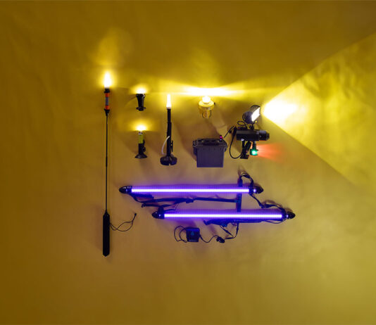 a selection of kayak lights laid out on a yellow backdrop