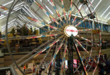 an indoor ferris wheel at a Scheels store where kayaks are sold