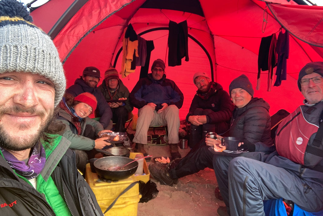 From left to right: Marcus, Wendy, Colin, Kim, Ken, Keith, Louise and Stuart hunkered down for breakfast in the Hilleberg