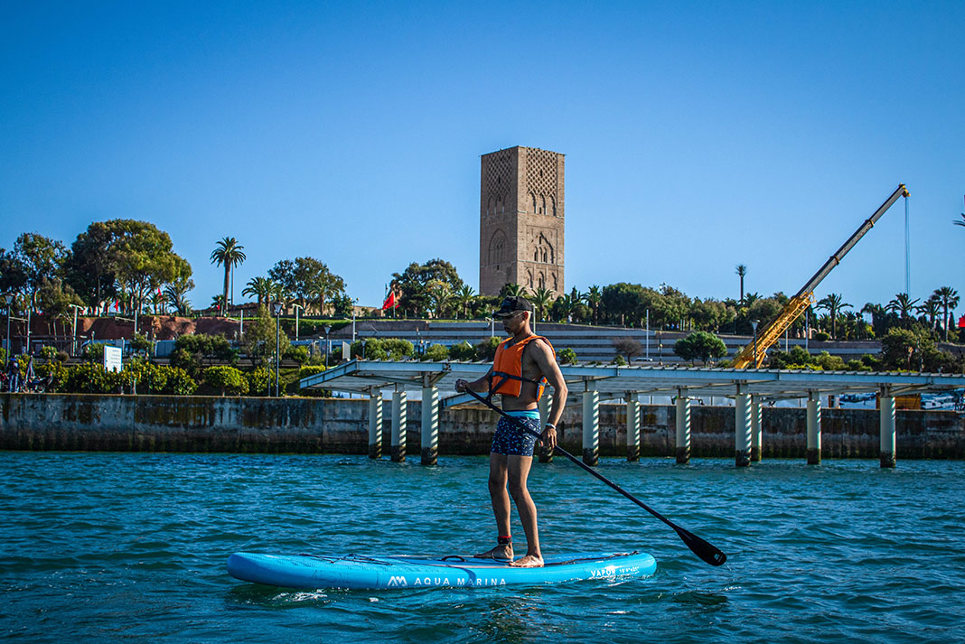 man stands and paddles a beginner paddleboard
