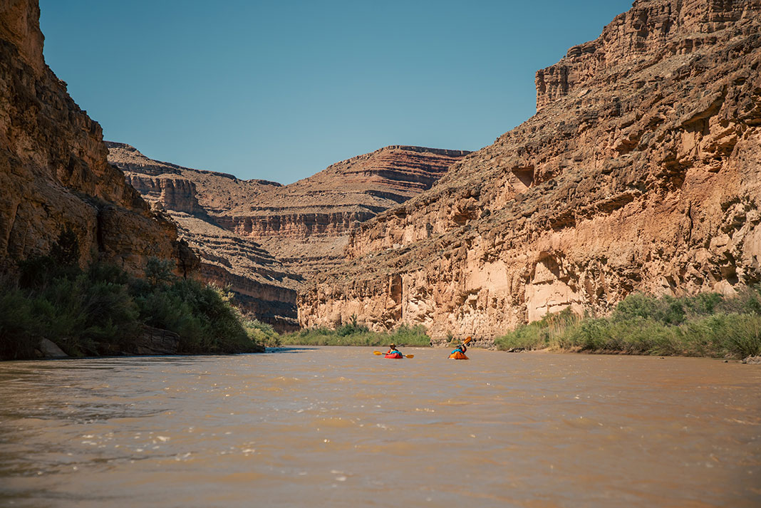 paddlers float down a Utah river while on a river trip