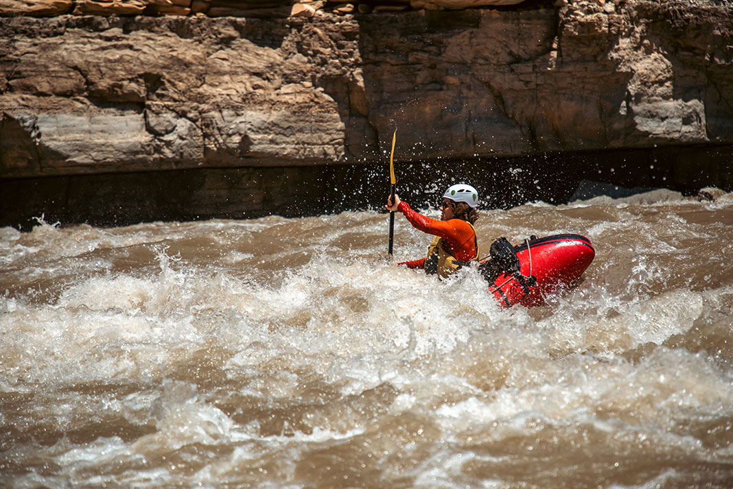 man kayaks through rapids on a San Juan River trip