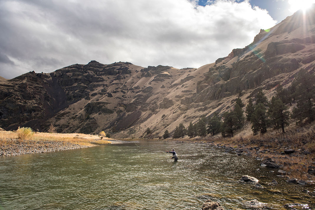 man wade fishes in the John Day River
