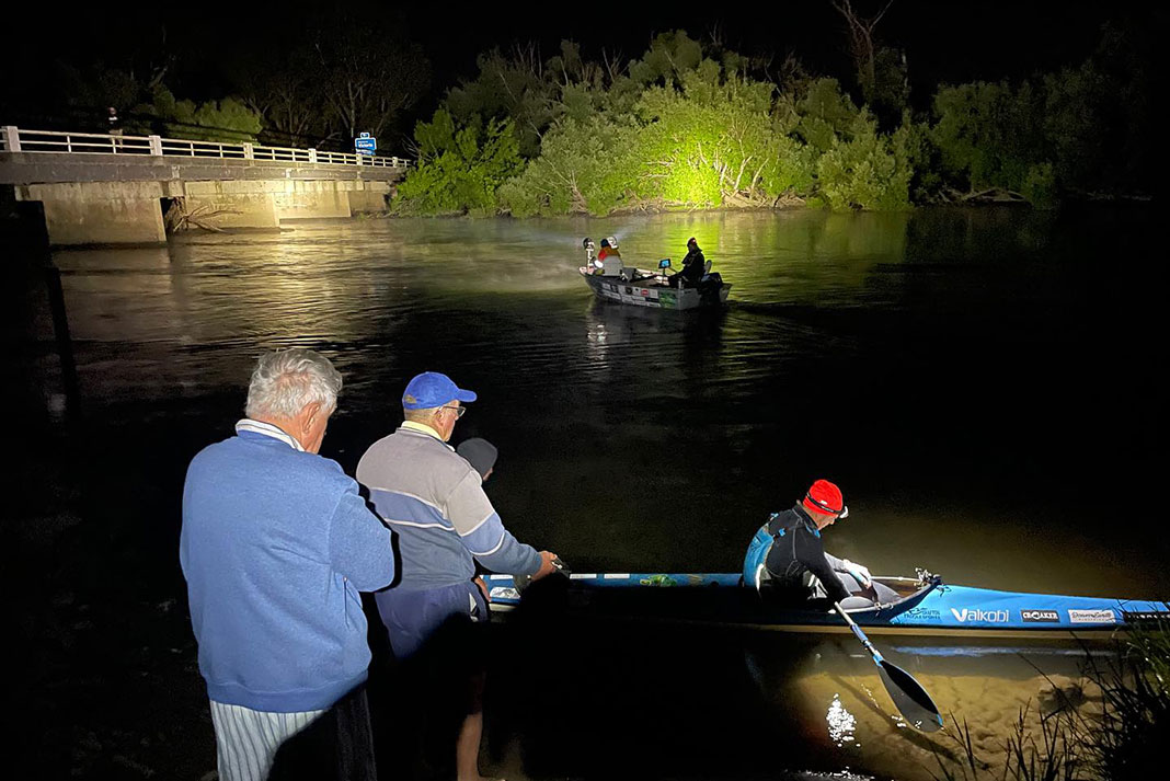 Dave Alley launches his kayak at night during a speed record attempt down the Murray River