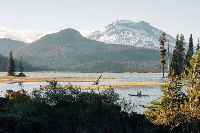 a kayaker paddles on a trip through beautiful Oregon scenery in America