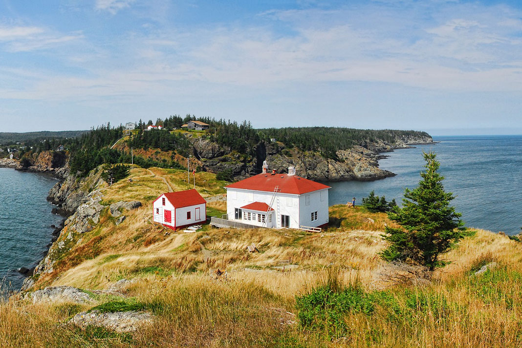 Buildings sit on a rocky spit on Grand Manan Island in New Brunswick