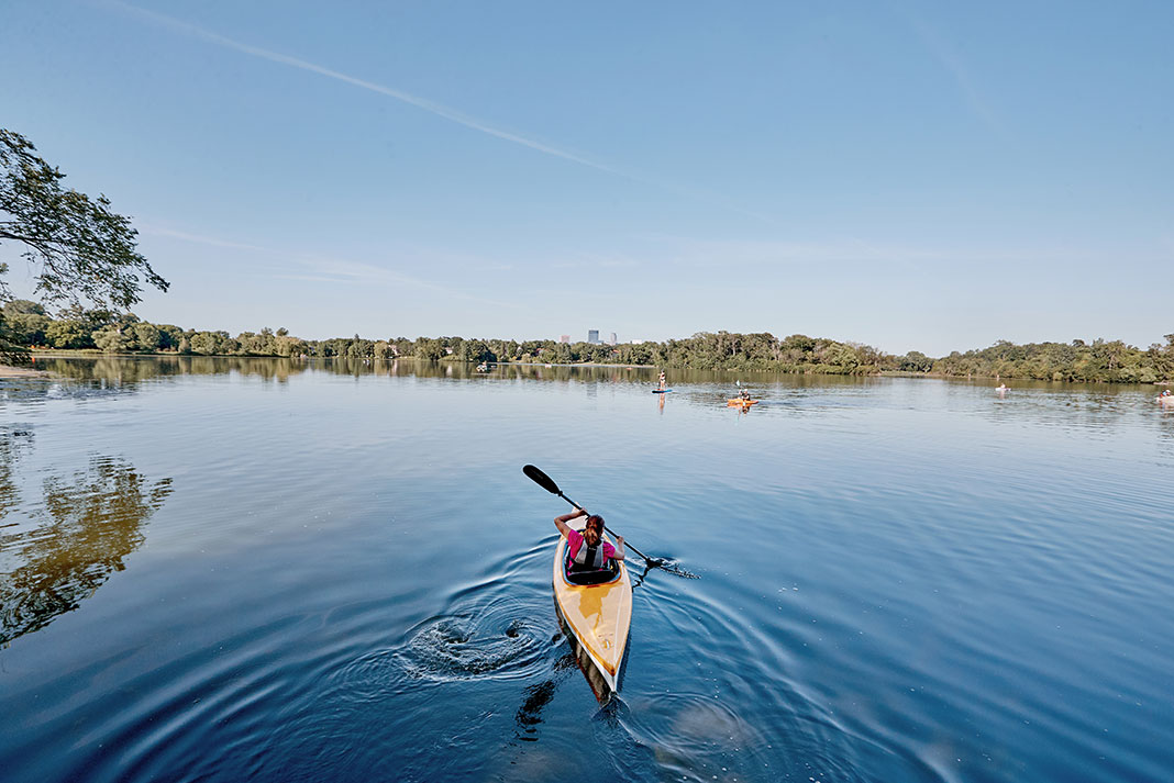 woman and dog kayak on Minnesota's Chain of Lakes