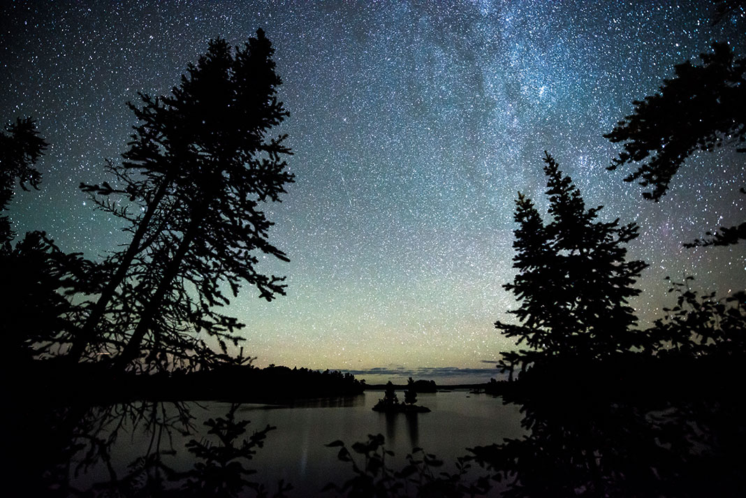 night time view of a lake with tons of stars in the sky in Voyageurs National Park