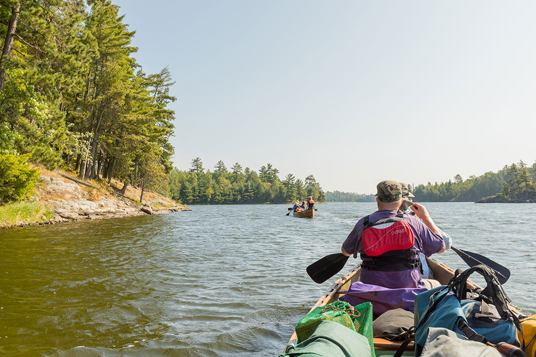 canoe trippers in two canoes paddle through Voyageurs National Park in Minnesota
