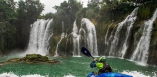 A Jackson Kayak paddler using a Werner Paddle as they go over a waterfall.