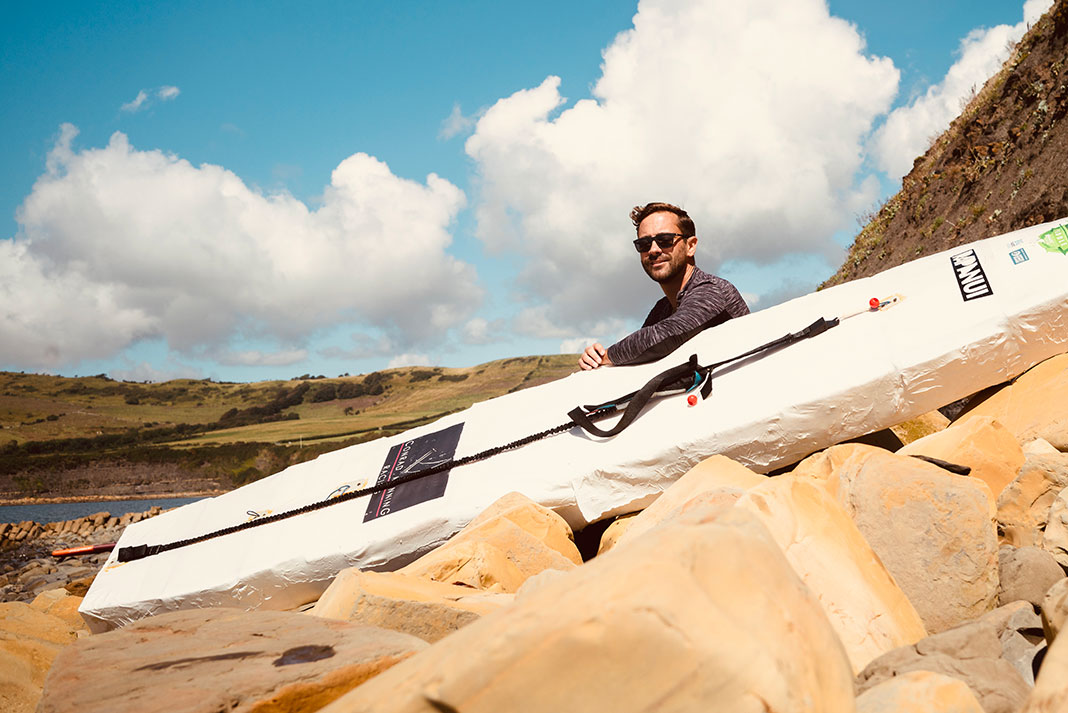 David Haze poses with his homemade standup paddleboard