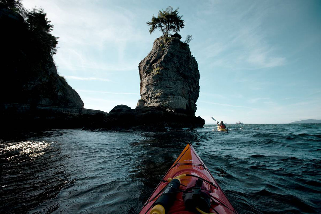bow shot of a kayakers paddling toward a flowerpot island near Vancouver