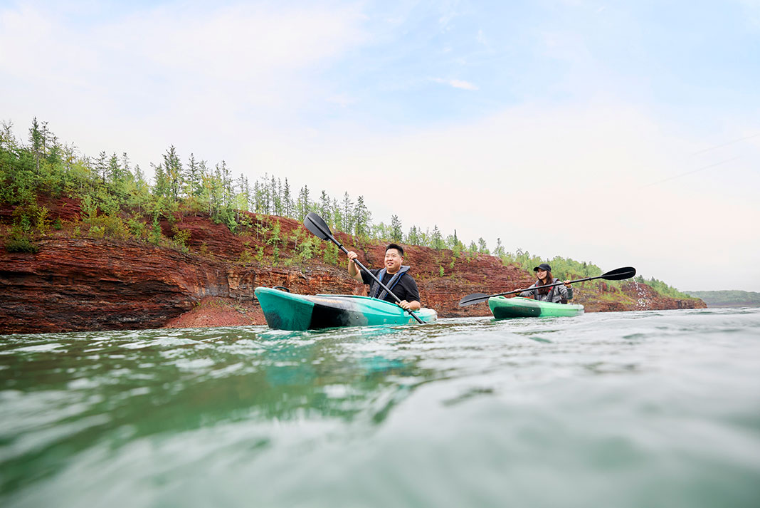 two family members kayaking in Minnesota on a paddling trip