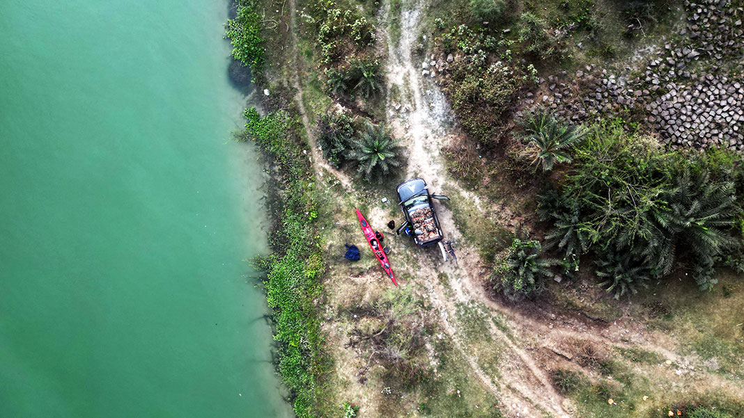 overhead view of a lush tropical website with kayak and jeep in India