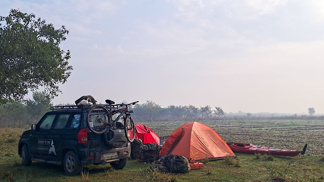 a jeep is parked beside a kayaking campsite in India
