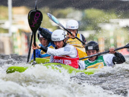 a group of paddlers compete in kayak cross in advance of its Olympics debut