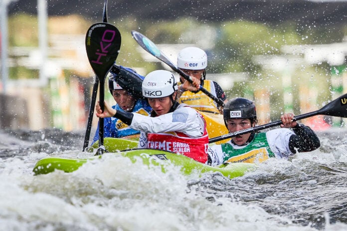 a group of paddlers compete in kayak cross in advance of its Olympics debut