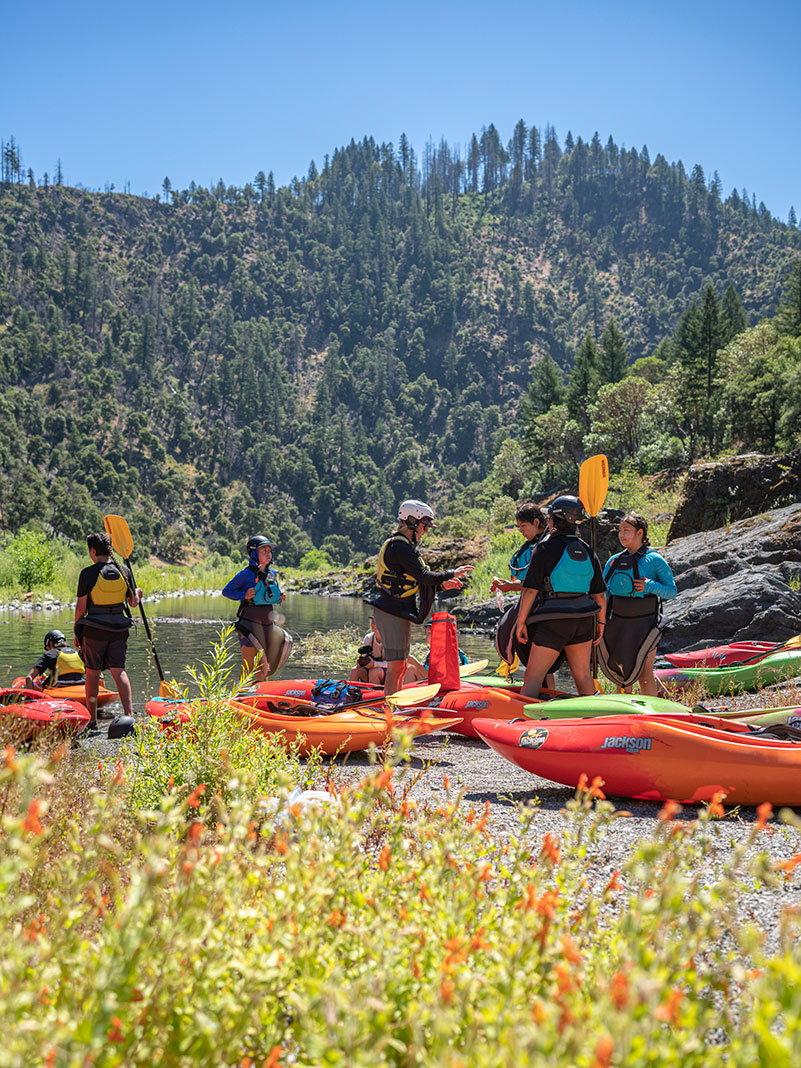 a group of Indigenous youth learning to whitewater kayak on the restored Klamath River