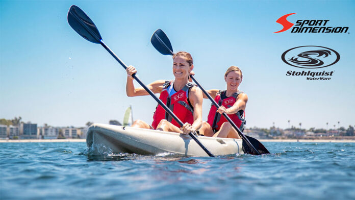 two women paddle a tandem kayak on a sunny day while wearing Stohlquist PFDs, recently acquired by Sport Dimension