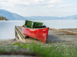 red tripping canoe sits loaded on a dock along the Columbia River
