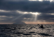 silhouetted view of Freya Hoffmeister on one of her greatest kayaking expeditions