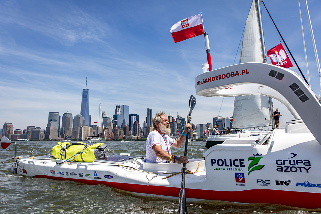 Aleksander Doba paddles out of New York harbor in Olo, his live-aboard kayak