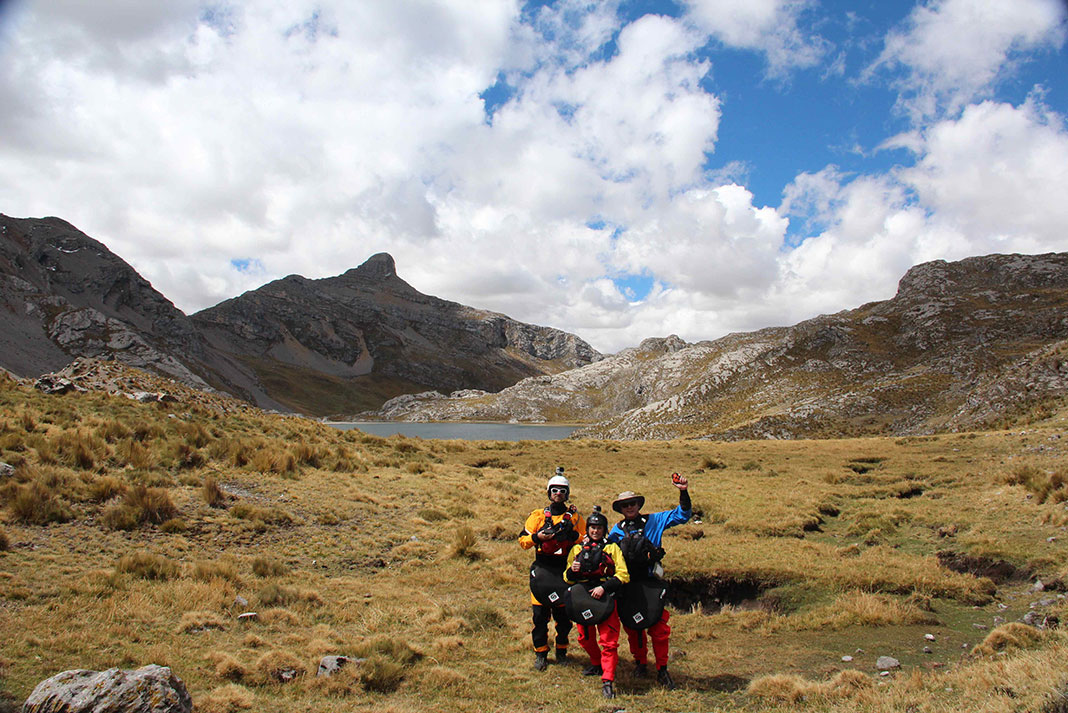 three expedition paddlers pose near the headwaters of the Amazon