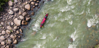 overhead view of a tandem paddling expedition boat travelling down a river