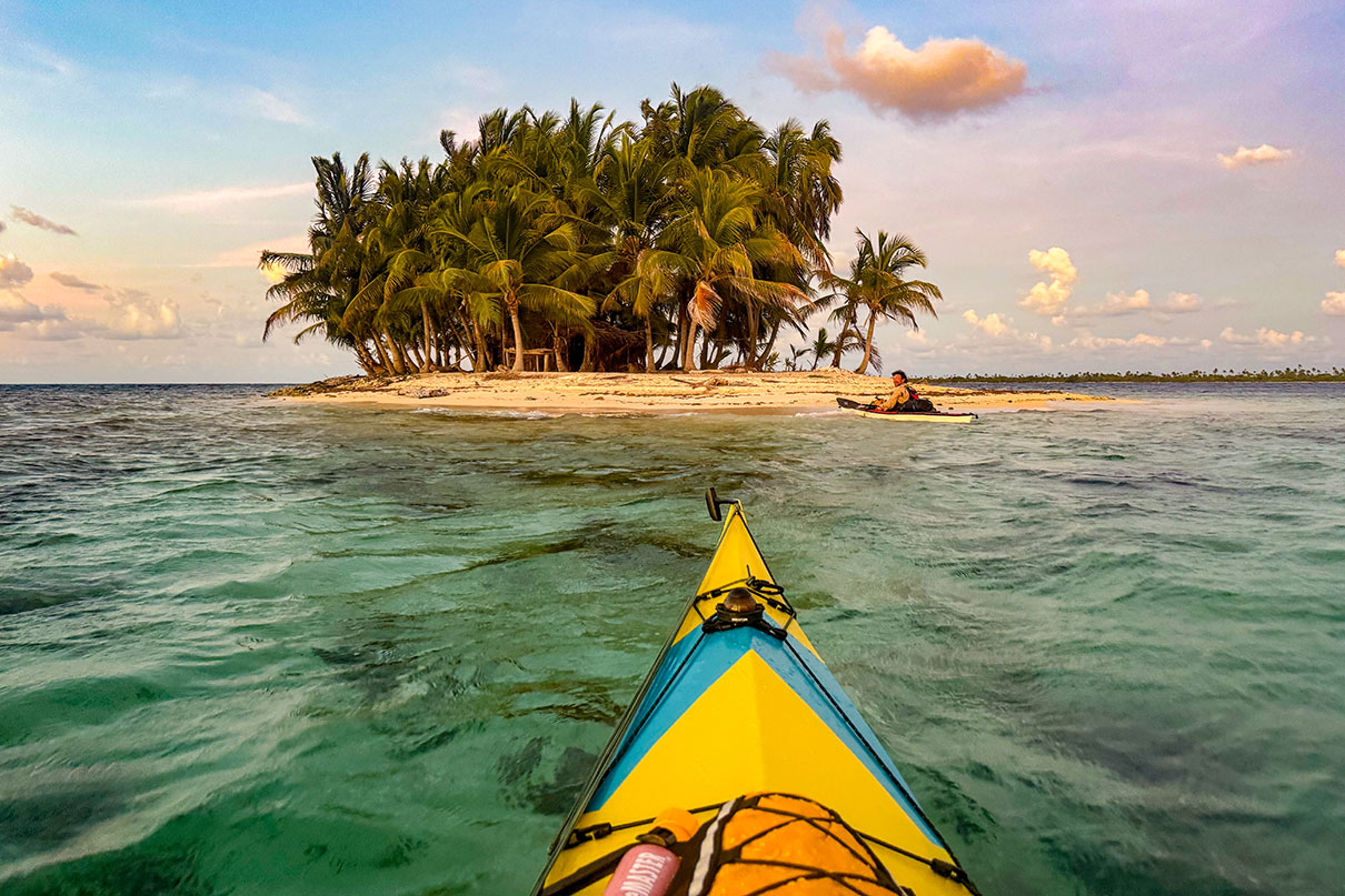 two sea kayakers approach a small island in the Darien Gap