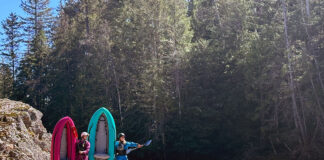 two women kayakers pose by the water with AIRE's Spud and Tater inflatable whitewater kayaks