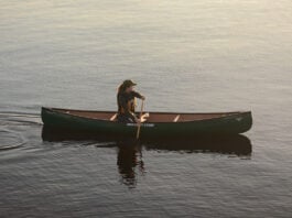 woman paddles the Nova Craft Canoe Prospector 14 solo canoe