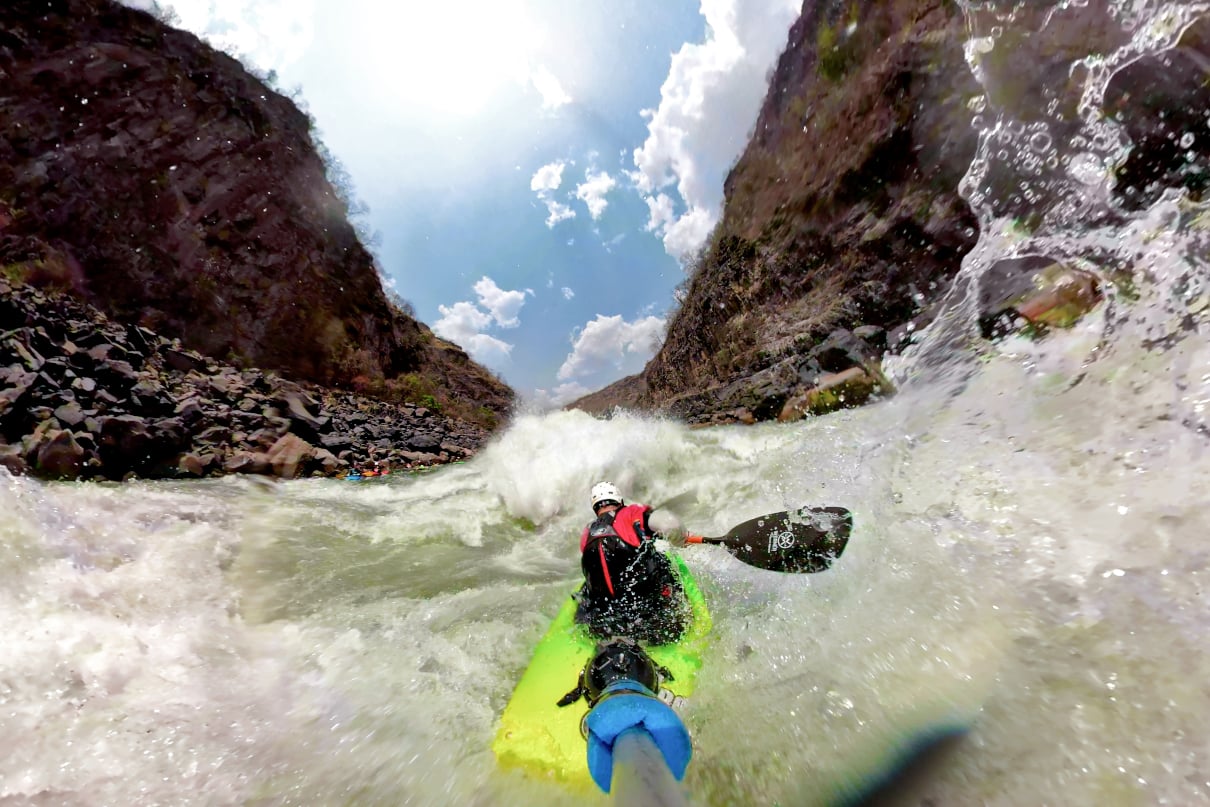 Kayaker running rapid on the Zambezi River.