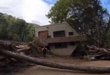 Paddler approaches home in ruin following wake of Hurricane Helene.