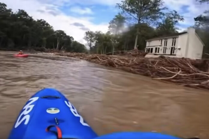 Kayakers paddle river to reach people stranded by Hurricane Helene.