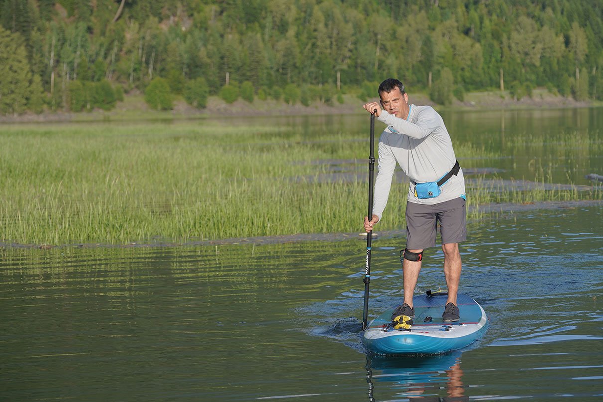 Man showing how to paddle board.