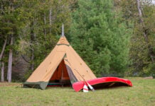 a luxury wilderness camping tent from Tentipi with high-end canoe and paddle