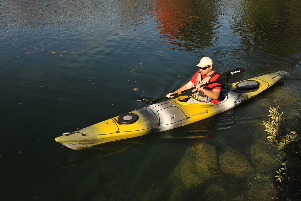 man paddles the Wilderness Systems Tsunami touring kayak