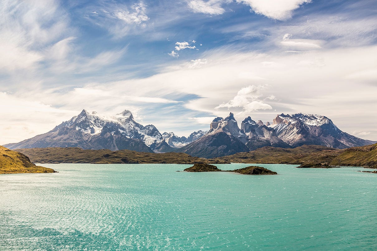 turquoise waters in front of jagged Patagonian mountain peaks